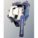 A cricket bag containing cricket bat, pads and shoes.