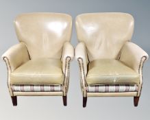 A pair of armchairs in studded beige vinyl