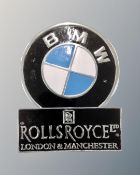 Two aluminium wall plaques, Rolls Royce London and Manchester and BMW.