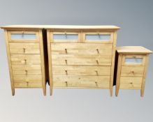 A contemporary pine three piece bedroom suite comprising six-drawer chest,
