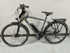 A Raleigh Motus tour electric bike powered by Bosch, with charger,