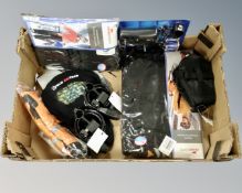 A box of new cycling accessories to include bike locks, gel seats, accessory pack,