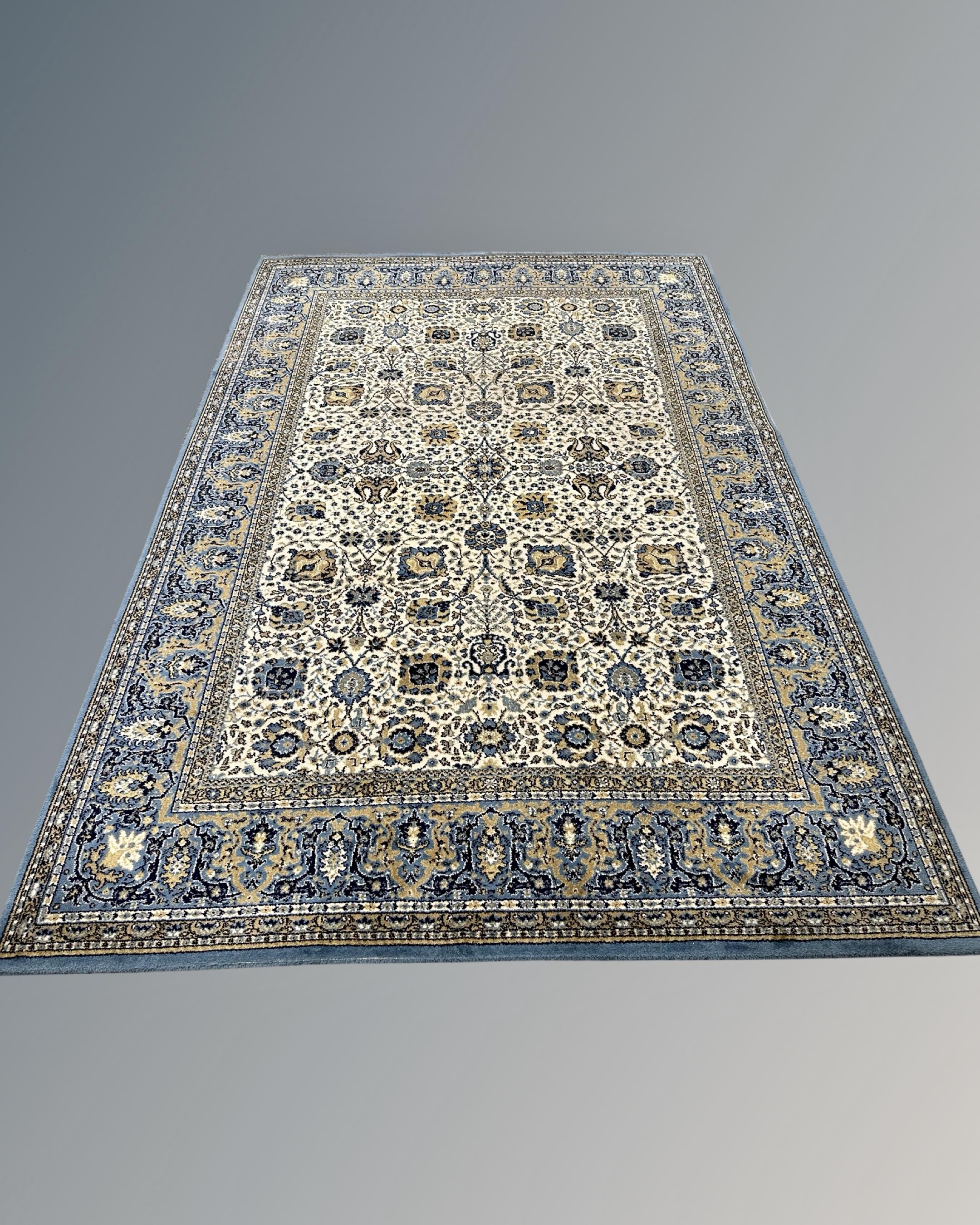 A machine-made Tabriz design rug, 201cm by 297cm.