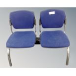 A metal framed triple section fixed seat upholstered in a blue fabric.