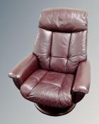A Scandinavian Burgundy leather upholstered swivel armchair