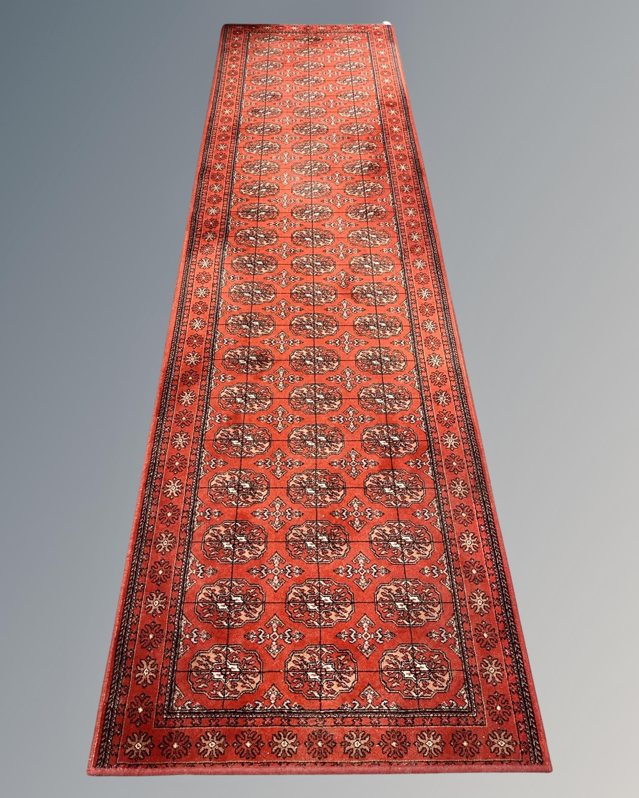 A machine-made Bokhara design runner, 91cm by 330cm.