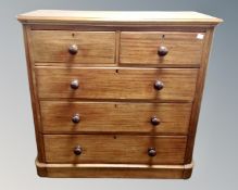 A Victorian mahogany five drawer chest with knob handles