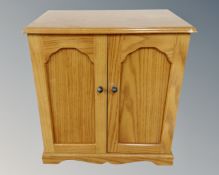 A contemporary table top double door cabinet fitted seven internal drawers