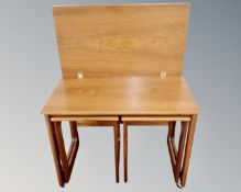 A nest of three mid 20th century teak McInstosh triform tables (one with turn over top)