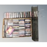 Two metal CD racks together with a box containing a large quantity of CDs including AC/DC,