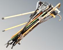 A bundle of assorted walking and shooting sticks.