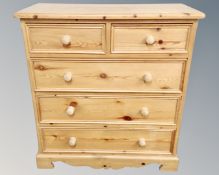 A Victorian style pine five drawer chest
