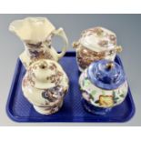 Four pieces of Maling lustre ware including jug, lidded biscuit barrel and two lidded vases.