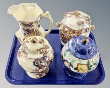 Four pieces of Maling lustre ware including jug, lidded biscuit barrel and two lidded vases.