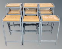 A set of nine science lab stools on metal legs.