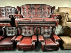 An oxblood buttoned leather three piece Chesterfield lounge suite
