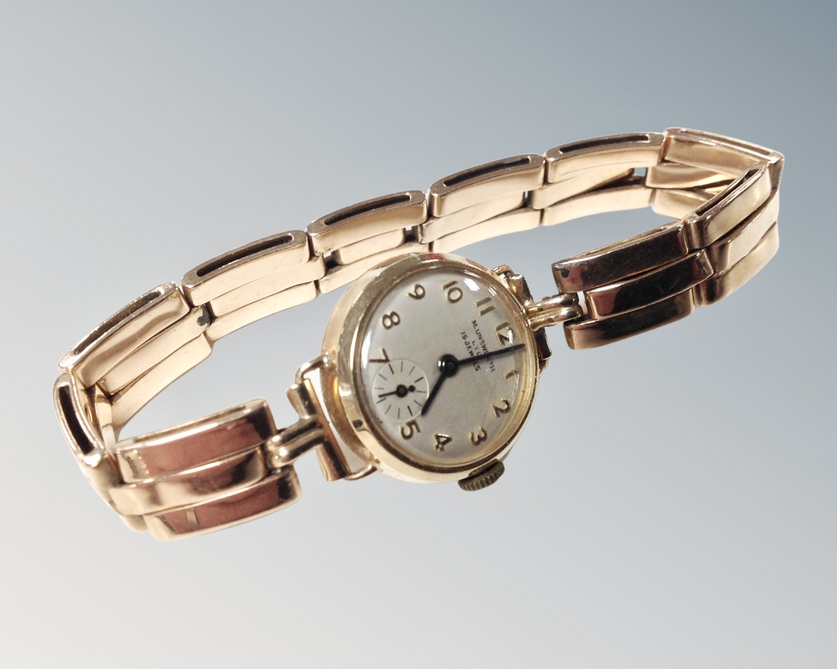 A lady's 9ct gold cased wristwatch on 9ct gold bracelet strap, 15 jewels, Swiss made.