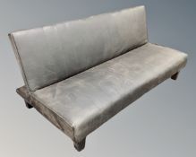 A faux leather folding bed settee.