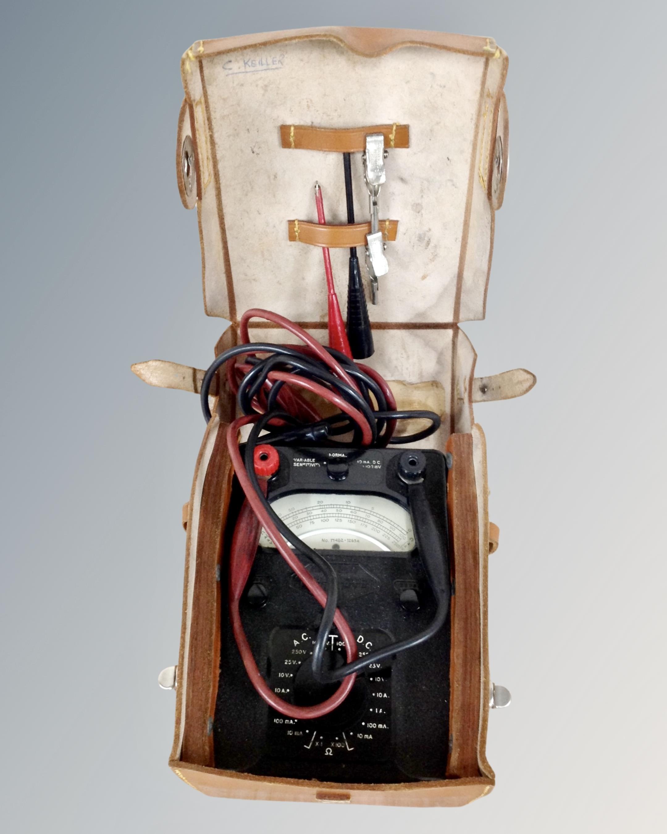 A vintage Bakelite cased avometer in leather case