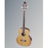A Woodstock model WHBASSEQ203 semi-acoustic bass guitar