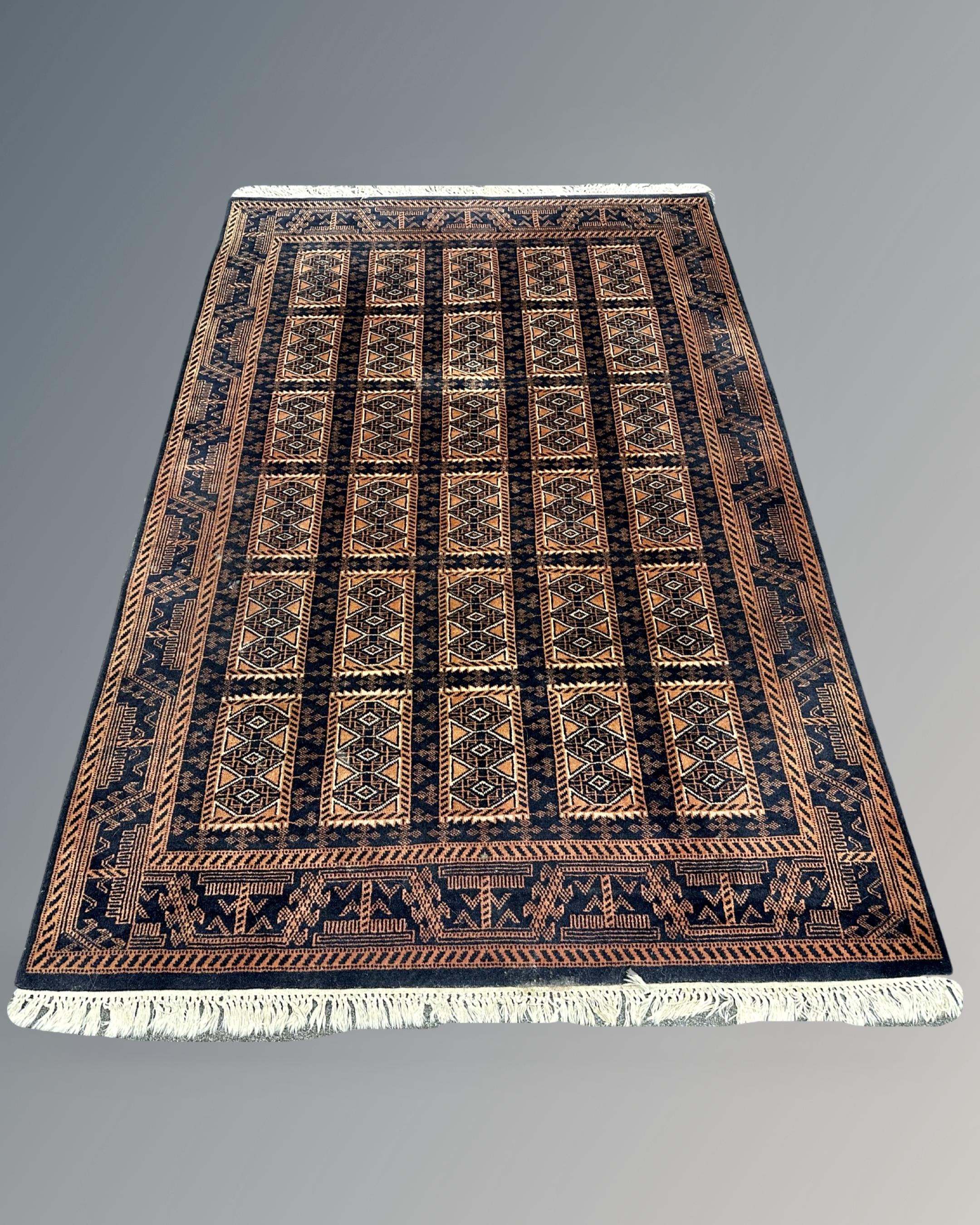 An Afghan rug of geometric design, 150cm by 224cm.