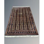 An Afghan rug of geometric design, 150cm by 224cm.
