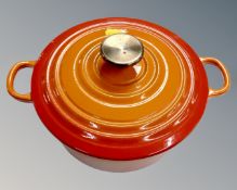A cast iron twin handled lidded oven dish (internal diameter 22cm)