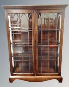 A Bevan Funnell Reprodux double door glazed bookcase fitted with internal shelves
