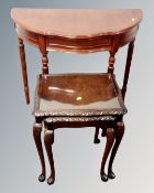 A nest of two beech and walnut glass topped tables,