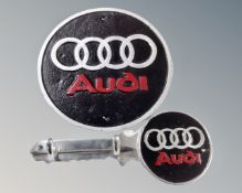 A cast iron wall plaque, Audi, together with an aluminium two hook wall rack.