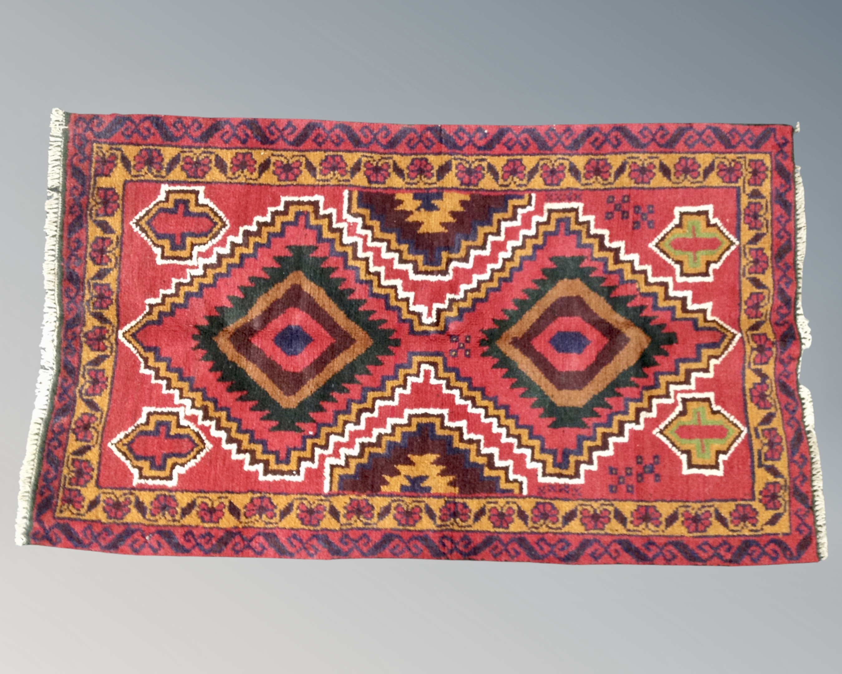 A Baluchi rug 188cm by 77cm