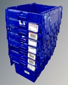 Eight blue plastic tote crates with lids.