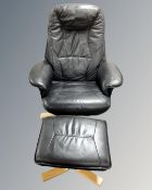 A Scandinavian black leather upholstered swivel armchair and matching footstool