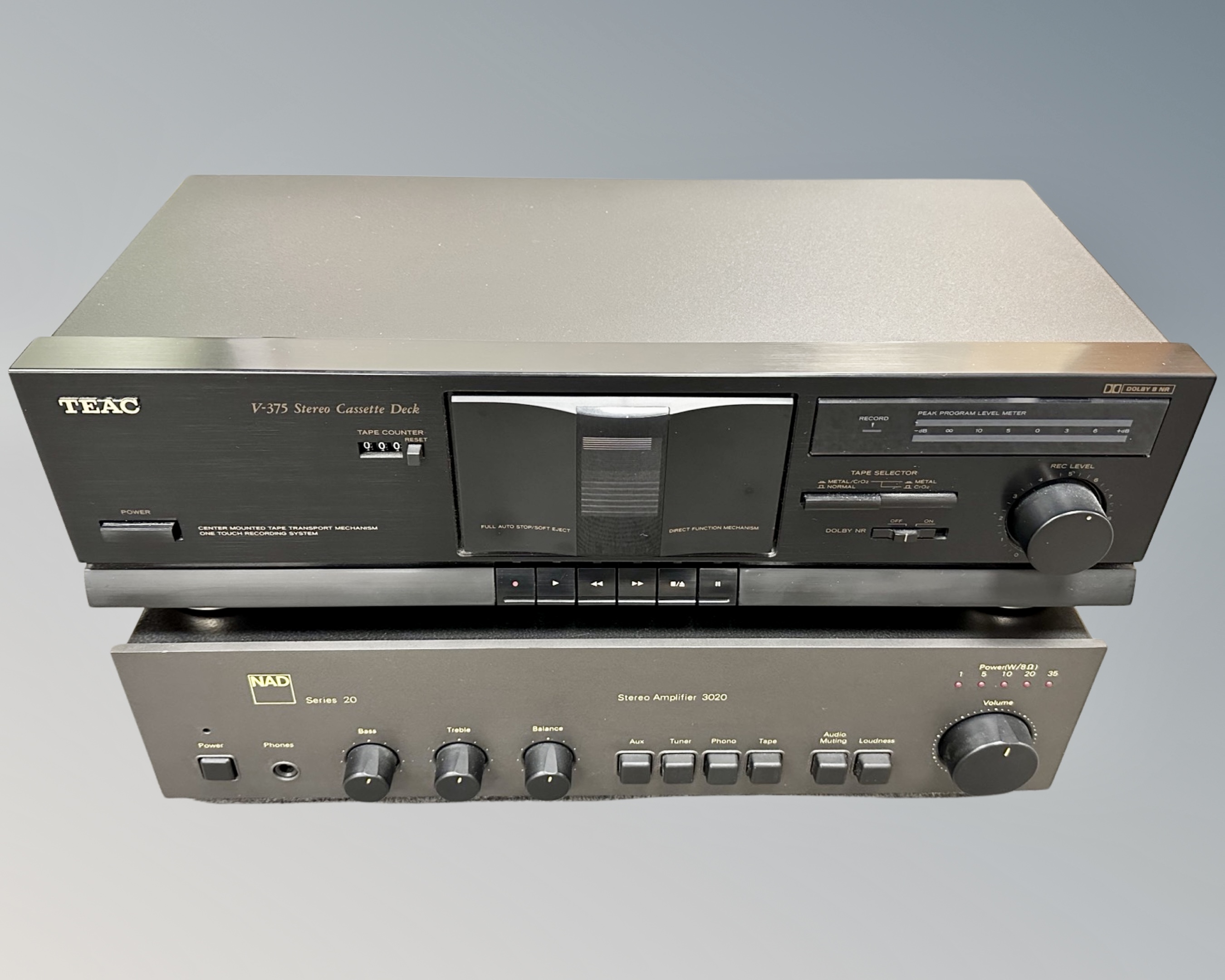 An NAD Series 20 stereo amplifier together with a Teac stereo cassette recorder, with leads.