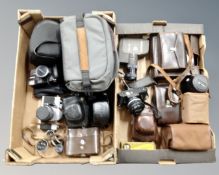 Two boxes of vintage and later cameras, camera bags to include Praktica, Nikon, Canon etc,