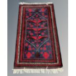 An Iranian Hamadan rug, 111cm by 188cm.