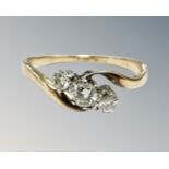 An 18ct gold and platinum three stone diamond ring, size Q. CONDITION REPORT: 2.