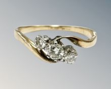 An 18ct gold and platinum three stone diamond ring, size Q. CONDITION REPORT: 2.