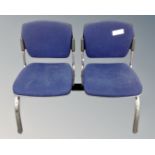 A metal framed double section fixed seat upholstered in a blue fabric.