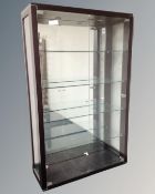 A contemporary glazed double door display cabinet fitted internal shelves