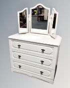 A contemporary three drawer dressing chest with triple mirror in a cream finish