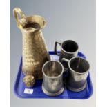 A tray containing an antique brass water jug together with a brass owl ornament and three pewter