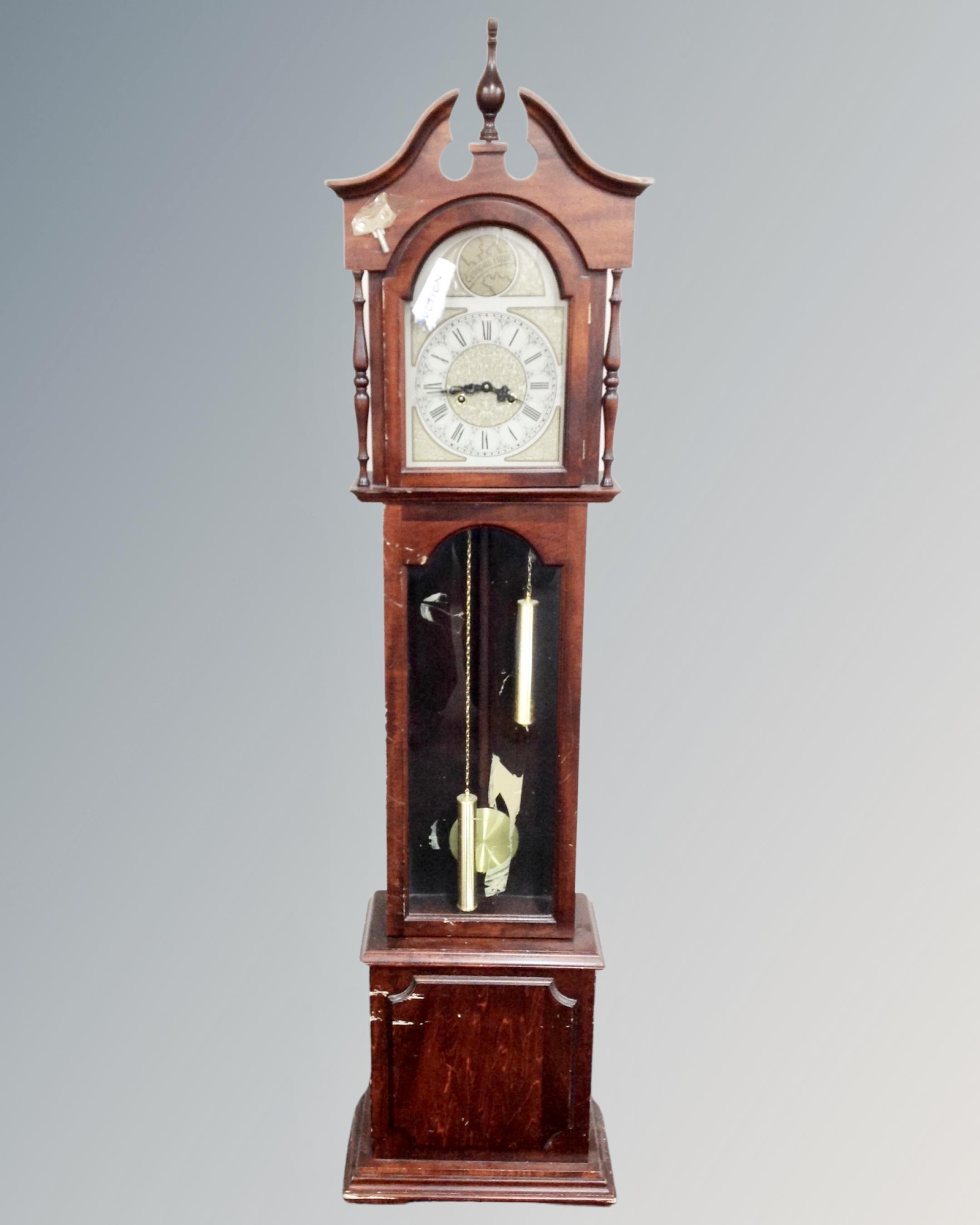 A Tempus Fugit granddaughter clock with pendulum key and weights.