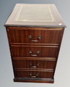 A reproduction mahogany two drawer filing chest with green tooled leather panel