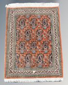 A finely woven Ghom rug, Central Iran, on salmon ground,
