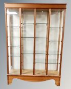 A 20th century four section glazed curio cabinet
