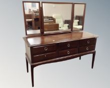 A Stag Minstrel six drawer dressing table with triple mirror
