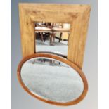 A contemporary hardwood mirror together with an antique oval mahogany mirror