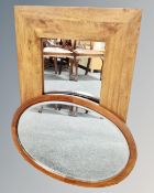 A contemporary hardwood mirror together with an antique oval mahogany mirror