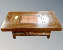 A Korean coffee table with copper inset trough fitted with three drawers